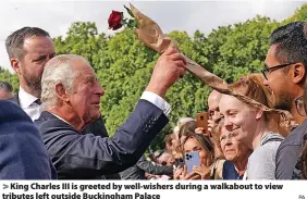  ?? PA ?? King Charles III is greeted by well-wishers during a walkabout to view tributes left outside Buckingham Palace