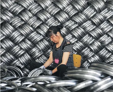  ?? AFP/GETTY IMAGES FILES ?? A worker checks wheel hubs of baby carriages that will be exported at a factory in Hangzhou, China. The USMCA contains a clause that has fuelled worries that Washington is using the new deal to entangle Canada and Mexico in its trade war with Beijing.