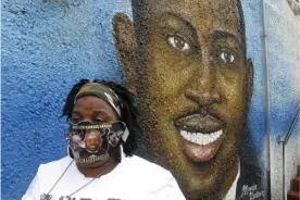  ?? Russ Bynum/AP ?? Thea Brooks stands in front of a mural of her slain nephew, Ahmaud Arbery, in Brunswick, Georgia, on 5 October 2021. Brooks calls the killing a ‘modern-day lynching’. Photograph: