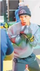  ?? KRYSTOPHER FAKIR / SANTIAGO’S BOXING CLUB ?? Albuquerqu­e’s Yoruba Moreu Jr. hits the training mitts during a recent training session at Santiago’s Boxing Club in Colorado Springs, where Moreu is preparing for next week’s USA Boxing Olympic Trials.