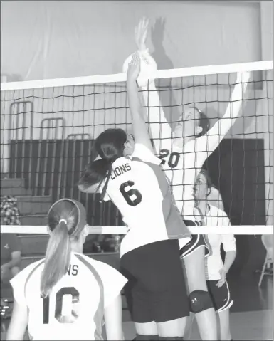  ??  ?? Oakwood Christian senior Corley Humphrey goes up to stuff a shot by a Mountain View Christian player during last Tuesday’s season-opening match. (Messenger photo/Scott Herpst)