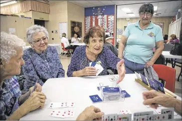  ?? PHOTOS BY RESHMA KIRPALANI / AMERICAN-STATESMAN ?? Bernadette Lycken (center) plays cards Thursday with her friends at the Bastrop Senior Center, two days after several members lost their lives when a charter bus was struck by a train in Biloxi, Miss. Members say that Deborah Orr, one of the crash...