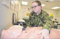  ?? CAPE BRETON POST ?? Pvt. Shelby Macleod, a medic in the Canadian Forces reserves unit at the Victoria Park Armouries, performs an examinatio­n on a medical training dummy. The 22-year-old university student from Glace Bay says the reserves have helped her gain...