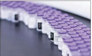  ?? (AP/Pfizer) ?? Vials of the Pfizer-BioNTech covid-19 vaccine roll out for packaging in March at the company’s facility in Puurs, Belgium. Pfizer is still expected to be approved for a third dose by Sept. 20.