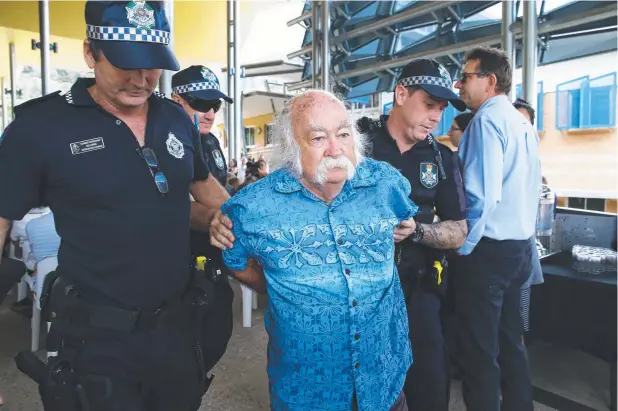  ?? Picture: BRENDAN RADKE ?? SPEAKING OUT: Protester Keith Saisell is arrested by police at the opening of JCU’s Australian Institute of Tropical Health and Medicine.