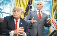  ?? Mandel Ngan / AFP / Getty Images ?? President Trump, joined by Vice President Mike Pence, issues an order to end his policy separating immigrant families.