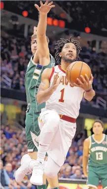  ?? TONY DEJAK/ASSOCIATED PRESS ?? Cleveland’s Derrick Rose drives to the basket against Milwaukee’s Mirza Teletovic in Nov. 7 action. The oft-injured Rose has left the Cavaliers and is pondering his basketball future.