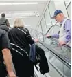  ?? DAVID GOLDMAN/THE ASSOCIATED PRESS ?? Rev. Frank Colladay Jr., right, talks to passengers trying to make a connecting flight in Atlanta.