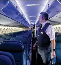  ?? Star Tribune/NICOLE NERI ?? Flight attendant Jonathan Herseth checks out the interior of the new Delta A220.