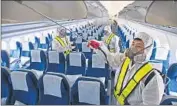  ?? Han Jong-chan
Yonhap ?? WORKERS spray an antiseptic solution in a plane at the internatio­nal airport in Incheon, South Korea.