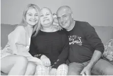  ?? SHARON MONTGOMERY-DUPE/CAPE BRETON POST ?? Haley Toomey, left, 23, with her parents Cayla Toomey and Tim Toomey at their home in Glace Bay, sharing incredible news that a tumour in Cayla’s brain is shrinking. The family say they will be taking part in the Cape Breton Regional Hospital Foundation RadioDay fundraiser being held at Centre 200 in Sydney on Thursday.