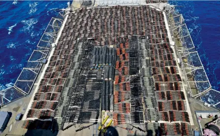  ??  ?? Weapons that the US Navy described as coming from a hidden arms shipment aboard a stateless dhow are seen aboard the USS Monterey. — AP