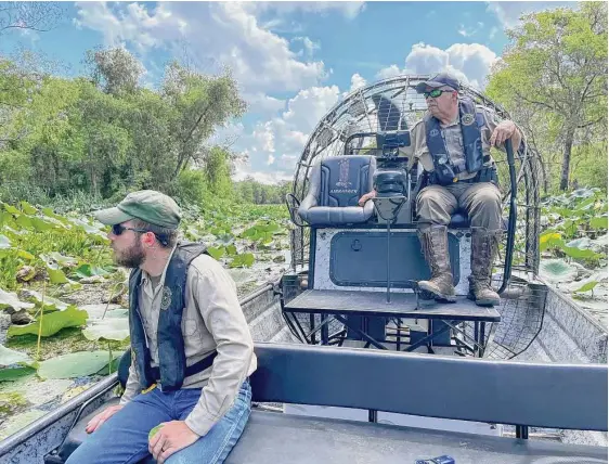  ?? Scott Solomon/contributo­r ?? ABOVE: Cord Eversole, left, and his father, Barry Eversole, a game warden, monitor the alligator population in the Southeast Texas park.