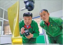  ?? PHOTOS BY YANG SHIYAO / XINHUA ?? Han (left) tests the blade of a steam turbine in his company’s workshop.