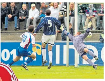  ??  ?? Rab Douglas is left helpless as John Petersen puts the Faroes 2-0 up in 2002. Scotland fought back for a draw