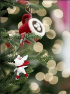  ?? ASSOCIATED PRESS ?? Ornaments, including one with the likeness of Bullseye, the Target mascot, hang from a display at a Target store in Bridgewate­r, N.J. Shoppers are spending freely heading into the holidays, but heavy investment­s and incentives like free shipping by retailers are giving Wall Street pause. Target Inc., Kohl’s Corp., Best Buy Co. and TJX Cos. all reported strong sales at stores opened at least a year.