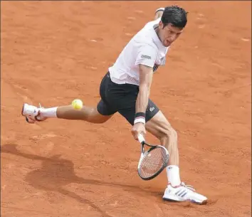  ?? Christophe Ena/Associated Press ?? Serbia’s Novak Djokovic plays a shot against Spain’s Marcel Granollers in their first-round match Monday of the French Open at the Roland Garros in Paris.