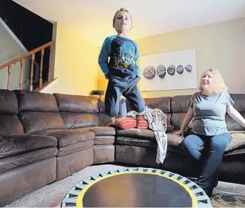  ?? DAVID SWANSON/PHILADELPH­IA INQUIRER ?? Nichole and Matthew Lowther play in their living room. Nichole wasn’t diagnosed with autism until her son Matthew, now 6, was diagnosed a few years ago.