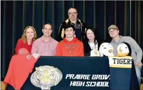  ?? SHELLEY WILLIAMS SPECIAL TO THE ENTERPRISE-LEADER ?? Prairie Grove senior Garrett Heltemes (center) signed a national letter of intent to play college baseball with Coffeyvill­e Community College, of Coffeyvill­e, Kan., on Dec. 7. His family gathered to celebrate (from left): Heather Heltemes, step-mother, Mike Heltemes, father; Garrett; Lee Heltemes, mother; and Gavin Heltemes, brother; with Prairie Grove baseball coach Chris Mileham (standing).