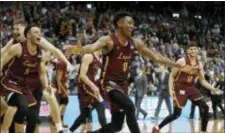  ?? THE ASSOCIATED PRESS ?? Loyola-Chicago players celebrate after winning an Elite Eight game in the NCAA Tournament against Kansas State on Saturday in Atlanta.