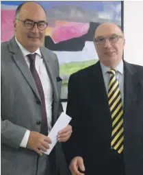  ??  ?? Martin Galea presenting the sponsorshi­p cheque to Prof. Roger Ellul Micallef