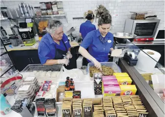  ?? LYNNE SLADKY, THE ASSOCIATED PRESS ?? Emma Gonzalez, left, and Lidices Ramos make empanadas at the Mendez Fuel convenienc­e store in Miami. There are no stale doughnuts and cold coffee at their store.