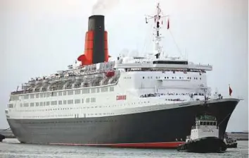  ?? Gulf News Archives ?? ■ The Queen Elizabeth 2 arrives in Dubai on November 26, 2008. It was welcomed by an armada of bobbing yachts as an overhead fly-past by an Emirates A-380 aircraft announced her arrival.