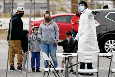  ?? Photos by Jerry Lara / Staff photograph­er ?? ABOVE: A family arrives at a COVID-19 testing site on South Zarzamora Street. More than half of San Antonio’s deaths related to COVID-19 have been among people who lived in three City Council districts on the West and South sides.