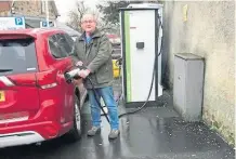  ?? ?? Councillor Bob Brawn charging up his hybrid car.