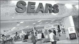  ??  ?? Shoppers walk into Sears in Peabody, Mass.