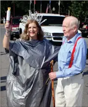  ??  ?? ABOVE: Cave Spring parade organizer Christa Jackson brings up the rear of the parade with 82-year-old Ed Hendrix.