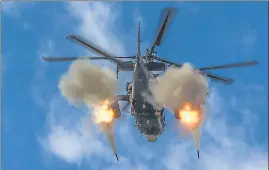  ?? AP ?? A helicopter gunship of the Russian air force fires rockets at a target in Ukraine, on Friday.