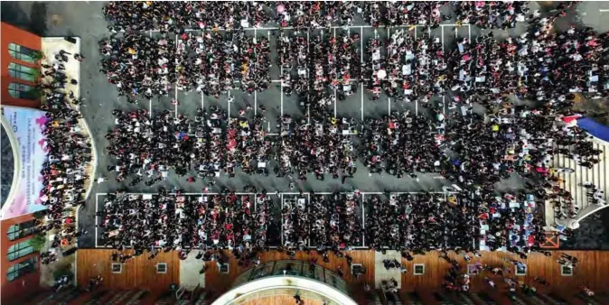  ??  ?? This aerial photo shows some 1,400 hairdresse­rs making haircuts as they attempt a Guinness world record for the largest number of people cutting hair at the same time in Shenyang, China’s northeaste­rn Liaoning province. — AFP