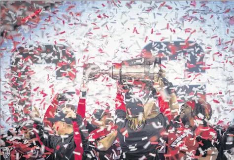  ?? CP PHOTO ?? Calgary Stampeders players hoist the Grey Cup trophy after defeating the Ottawa Redblacks in the 106th Grey Cup CFL game Sunday in Edmonton.