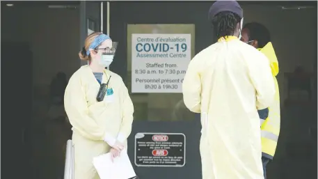  ?? JULIE OLIVER ?? Staff stand at the ready at the Brewer Park testing centre Thursday. Provincial officials are pledging to reduce the testing backlog.