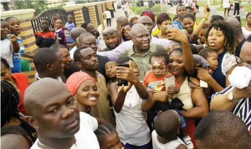  ?? Photo: Lagos Govt. House ?? Lagos State Governor, Akinwunmi Ambode (middle) with fun seekers at the JJT Park, Alausa, Ikeja yesterday, for the Easter celebratio­n