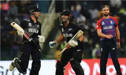  ?? Photograph: Indranil Mukherjee/AFP/Getty Images ?? Daryl Mitchell (centre) reacts to hitting New Zealand’s winning runs while Chris Woakes realises England are out off the T20 World Cup.