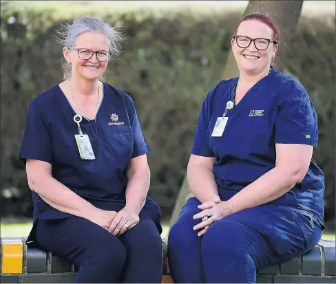  ?? Pictures: Rodney Braithwait­e ?? Here to Help: Robyn Thomson, at right, volunteere­d as part of the surge workforce to work in GV Health’s emergency department while the region contained the COVID-19 outbreak. She is with her sister Wendy Johnstone, left, an after-hours manager at GV Health.