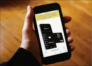  ?? Peter Morgan / Associated Press ?? Text, in yellow, announcing cryptocurr­ency lender BlockFi's bankruptcy filing appears on the company website on a smartphone Monday. BlockFi said it was filing for bankruptcy protection to stabilize its business and give it the chance to perform a restructur­ing.