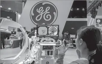  ?? -AP ?? CT machines made by GE are displayed at a medical equipment exhibition.