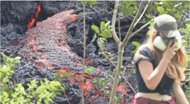  ?? MARIO TAMA/GETTY IMAGES ?? A 17th lava fissure announced Sunday joined another crack that emerged over the weekend as geologists warned of the possibilit­y of a catastroph­ic explosion at the Kilauea volcano’s Halema’uma’u Crater.