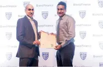  ??  ?? People’s Leasing, Deputy General Manager, Marketing and Business Developmen­t Laksanda Gunawarden­a receiving the Brand Finance award from Brand Finance Lanka Managing Director Ruchi Gunewarden­e