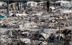  ?? LUIS SINCO/LOS ANGELES TIMES FILE PHOTOGRAPH ?? Residents clear away debris in Santa Rosa’s Coffey Park neighborho­od on Oct. 20, 2017.