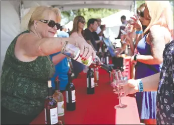  ?? NEWS-SENTINEL FILE PHOTOGRAPH­S ?? Above: Patty Johnson of One Way Winery at Zinfest in Lodi on May 16, 2015. Below left: Cyclists race through Downtown Lodi at Cyclefest presented by Michael David Winery on June 7, 2015. Below right: Visitors swirl wine glasses during Zinfest at Lodi...