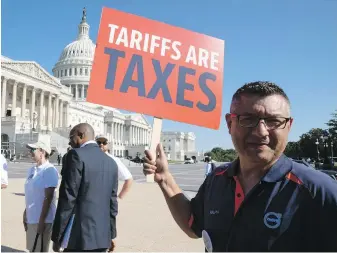  ??  ?? Ralph Garcia, a Volvo employee from South Carolina, participat­es in a rally by Americans who work for internatio­nal auto companies against auto trade tariffs Thursday on Capitol Hill in Washington, D.C.