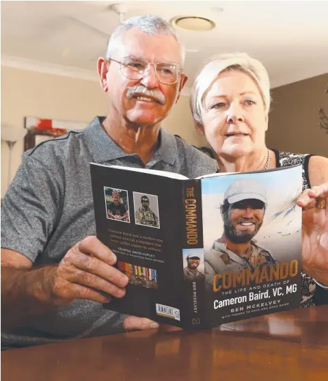  ??  ?? Doug and Kaye Baird, parents of VC recipient Cameron Baird, with the new book, The Commando, which tells the story of their son.