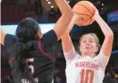  ?? KARL MERTON FERRON/ BALTIMORE SUN ?? Maryland guard Abby Meyers shoots over South Carolina forward Victaria Saxton during the first half of Friday night’s game in College Park.