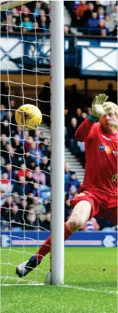 ??  ?? Joe Garner applies the finishing touch to his equaliser for Rangers at Ibrox as Motherwell keeper Craig Samson watches on Photograph: SNS