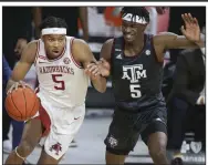  ?? (NWA Democrat-Gazette/Charlie Kaijo) ?? Arkansas guard Moses Moody (left) drives the ball as Texas A&M forward Emanuel Miller defends during the first half Saturday at Walton Arena in Fayettevil­le. Moody scored 28 points to lead the Razorbacks to an 87-80 victory. More photos at arkansason­line. com/37tamua/