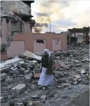  ?? JOHN MOORE / GETTY IMAGES ?? A Yazidi man walks through Sinjar, Iraq, in 2015, after liberation from ISIL.